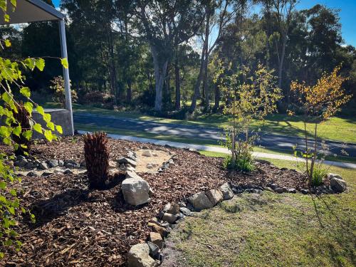 a garden with rocks in the middle of a yard at River Walk in Wynyard in Wynyard