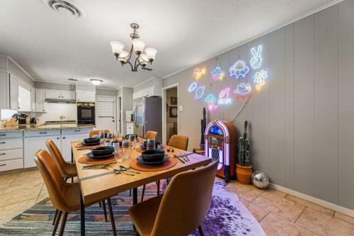 a dining room with a table and chairs and a kitchen at Spring nights, Fire Pit, BBQ, Games & Pet-Friendly in College Station
