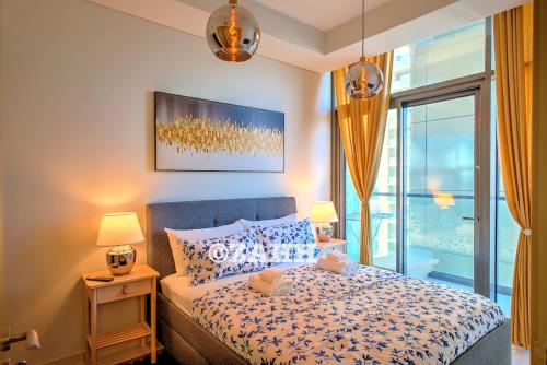 a bedroom with a bed with two lamps and a window at Business Bay Retreat in Dubai