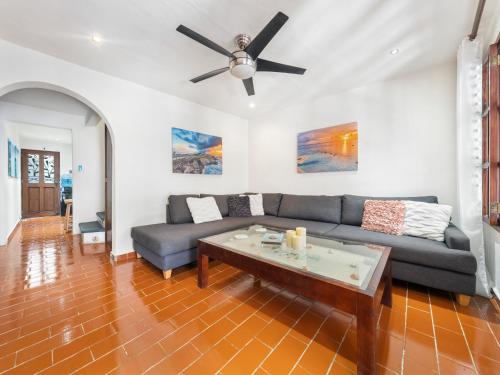 a living room with a couch and a ceiling fan at The Mermaid and The Pearl Boutique Hotel in Isla Mujeres