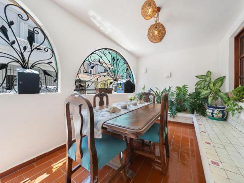 a dining room with a wooden table and chairs at The Mermaid and The Pearl Boutique Hotel in Isla Mujeres
