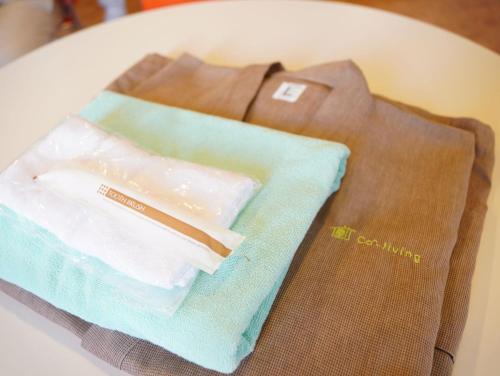 a brown shirt and a napkin on a table at ハタラコリビングみなのsubako in Minano