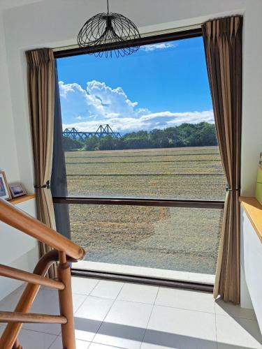 a room with a window with a view of a field at Sunrise Inari B&B in Dongshan