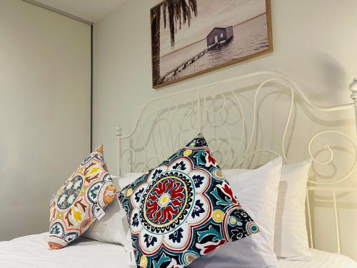 a bedroom with a white bed with pillows on it at Southbank Hidden Gem in Melbourne