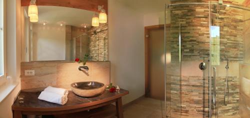 a bathroom with a sink and a shower at Überbacherhof in Termeno