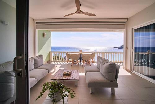 a living room with a view of the ocean at Blue Emerald Ocean's 8 in Willemstad
