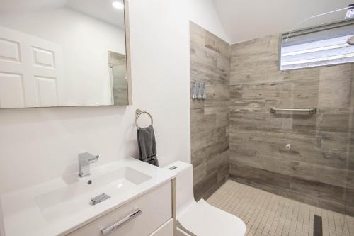 a bathroom with a white sink and a shower at The Caroline Suite in Key West