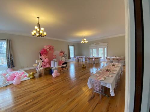 a large room with tables and pink and white balloons at Beautiful River front home with private pool in Phillipsburg