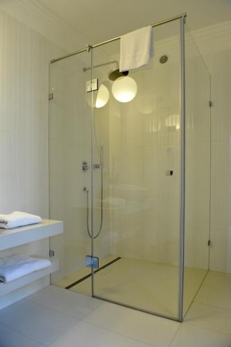 a shower with a glass door in a bathroom at Baltica Residence in Sopot