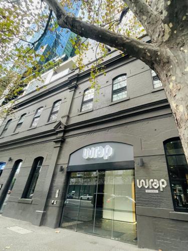 a store front of a building with a wrap sign on it at Southbank Hidden Gem in Melbourne