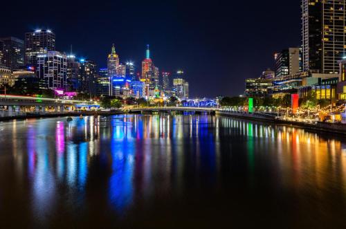 a view of a city at night with a river at Southbank Hidden Gem in Melbourne
