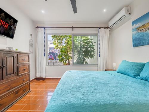 a bedroom with a bed and a large window at The Mermaid and The Pearl Boutique Hotel in Isla Mujeres