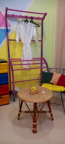 a table with a chair and a shirt hanging on a rack at Elena Garden Resort and Restaurant in Trincomalee
