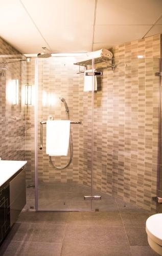 a bathroom with a shower with a glass door at T24 Residency Mumbai International Airport Hotel in Mumbai
