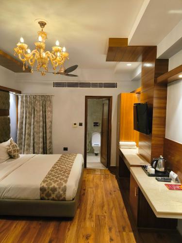 a hotel room with a bed and a bathroom at Hotel The Pearl, City Center - Traveler's Choice Award Winner for 2025 in New Delhi