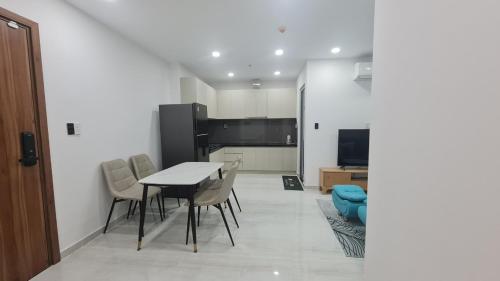 a kitchen and dining room with a table and chairs at Teddy Codotel of Happy one central in Ấp Phú Thọ