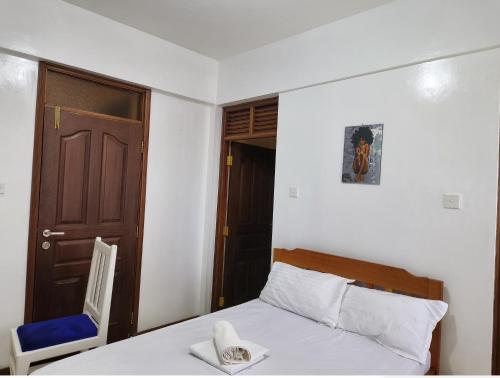 Postel nebo postele na pokoji v ubytování Barrizzi Studio Nyali Mombasa
