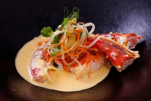 a plate of food with meat and vegetables on it at Miyakojima Kurima Resort Seawood Hotel in Miyako Island