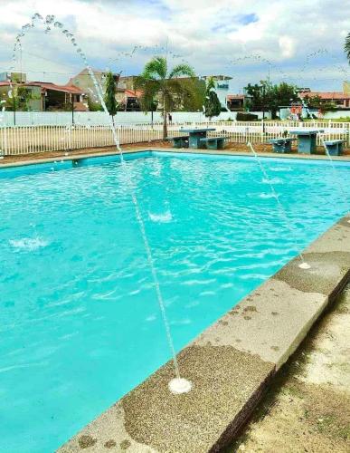 a fountain in a blue swimming pool at Soccour Homestay by ekc in Marilao
