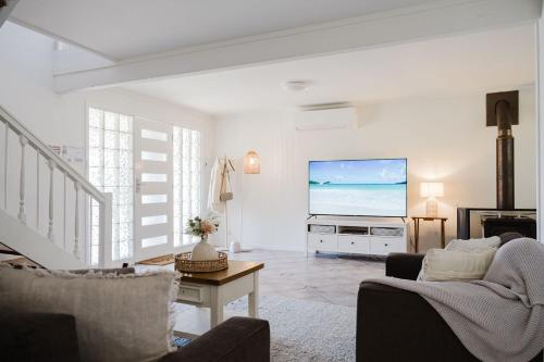 a living room with a large screen tv at Our Molly in Mollymook