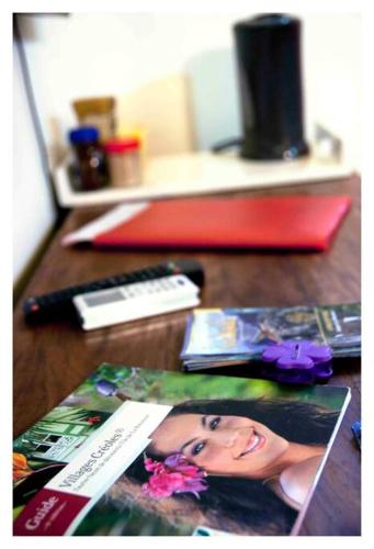 a wooden table with a picture of a woman at Dann Tan Lontan Ti Kaz Zépices Adults Only in Saint-Philippe