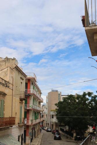 a city street with buildings and a blue sky at ROOMS 69- Appartaments Francesca e Comasia in Corato