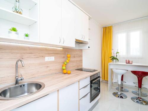 a kitchen with a sink and a counter at Apartments Bla evi - Comfort Two Bedroom Apt with Hot Tub and Sea View in Mlini