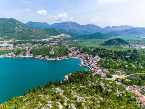 an aerial view of a town on a hill next to a lake at Apartments Ema - Studio Apartment with Sea View in Rogotin