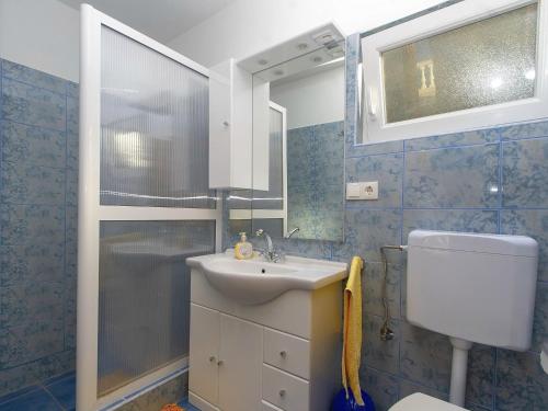 a bathroom with a toilet and a sink and a shower at House Green Side Sunset- Four Bedroom House with Pool and Sea View in Prigradica