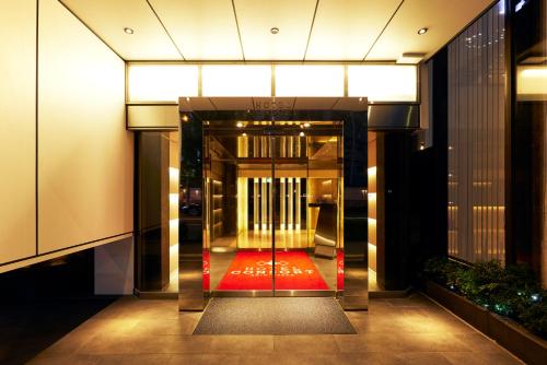 an entrance to a building with a red carpet at Hotel Consort Shin-Osaka in Osaka