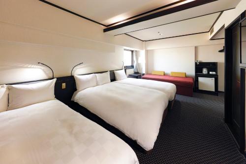 Postel nebo postele na pokoji v ubytování Hotel Consort Shin-Osaka