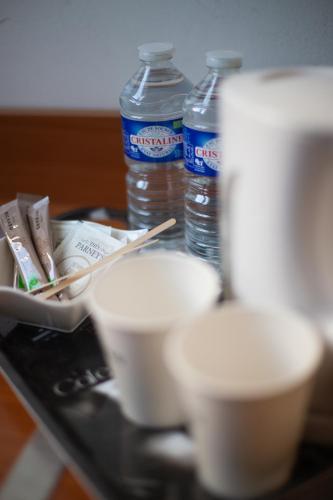 a tray with bowls and water bottles on a table at Hôtel Restaurant Du Château in Josselin