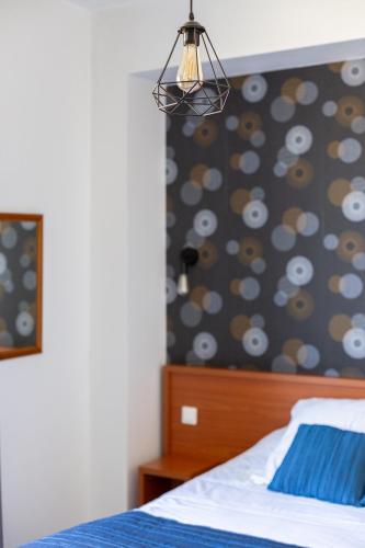 a bedroom with a bed with a blue comforter at Hôtel Restaurant Du Château in Josselin