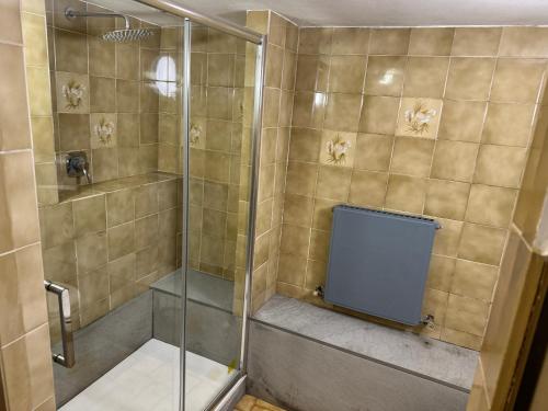 a shower with a glass door in a bathroom at Volta Como Lake apartament in Brunate