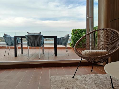a table and chairs on a balcony with a view at Seascape 19 in Mellieħa