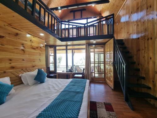 a bedroom with a bed and a staircase in a cabin at Baikunth Homes in Dalhousie