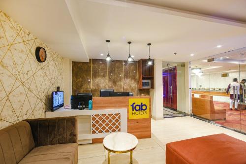 a lobby of a hotel with a couch and a table at FabHotel Prime Blest Park Near Yashobhoomi Convention Centre in New Delhi