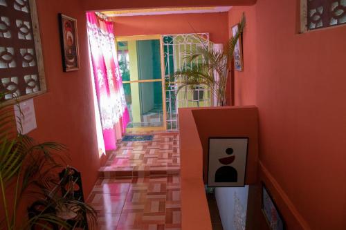 an orange hallway with a door with an apple on it at Roses Place in Brown Hill Village
