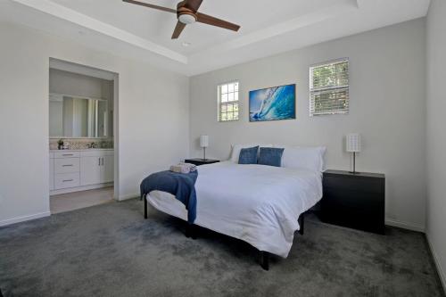 a white bedroom with a bed and a ceiling fan at Fun In The Sun 2 Bed 2 Bath Home in Oceanside