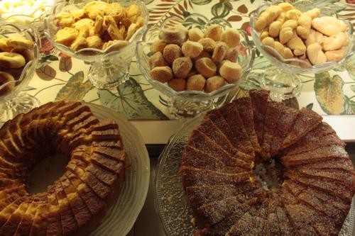 a table topped with lots of different types of pastries at Sul América Palace Hotel in Belo Horizonte