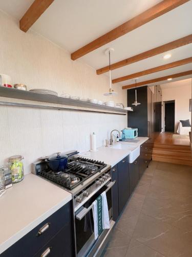 a kitchen with a stove and a counter top at Charming 2BR Cottage with Bay and City Views-Gated Luxury Private Place in San Francisco
