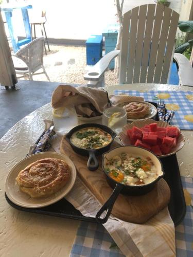 a table with plates of food on a table at Via Polonia - Boutique Studios Corfu in Agios Georgios