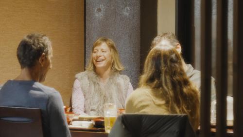 a group of people sitting at a table in a restaurant at Hotel Japan Shiga in Yamanouchi