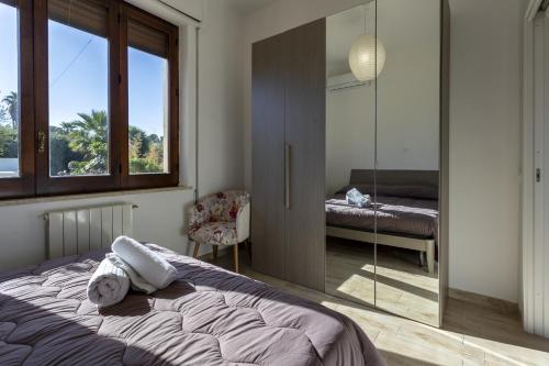 a bedroom with a bed and a mirror at Villa Stella in Marsala