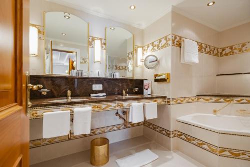 a bathroom with a sink and a mirror at Hotel Zürserhof in Zürs am Arlberg