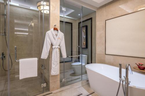 a bathroom with a bath tub and a sink at Solaire Resort Entertainment City in Manila