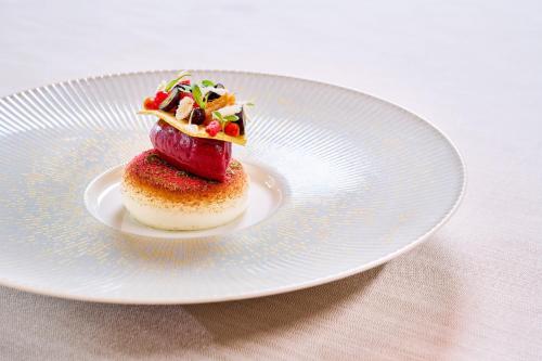 a white plate with a dessert on a table at Parkhotel Gütersloh in Gütersloh
