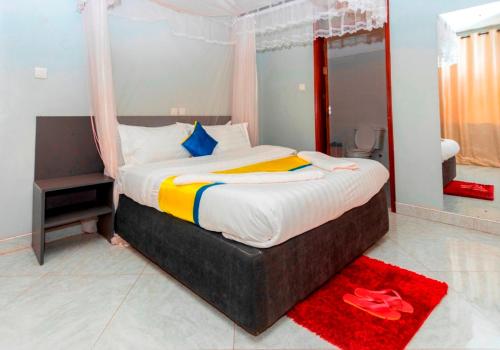 a bedroom with a large bed with a canopy at Sky Beach Hotel in Wakiso