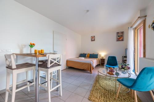 ein Zimmer mit einem Bett und einem Tisch und Stühlen in der Unterkunft Superbe appartement 1min métro7 Rez-de-chaussée in Aubervilliers