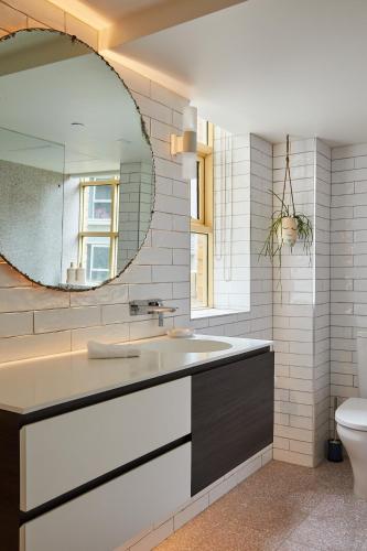 a bathroom with a sink and a mirror at Deco Loft on Russell Street in Melbourne
